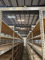 Top tie brace on industrial rivet shelving for seismic stability